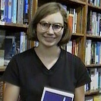 Melanie Daniels Young woman with glasses and a short, brown bob haircut